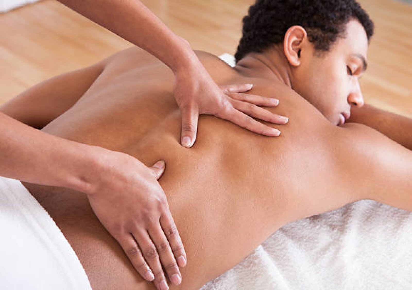 Portrait Of Man Receiving Massage Treatment From Female Hand